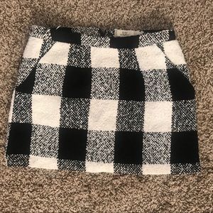 Polyester , rayon, cotton mini skirt. Has pockets.